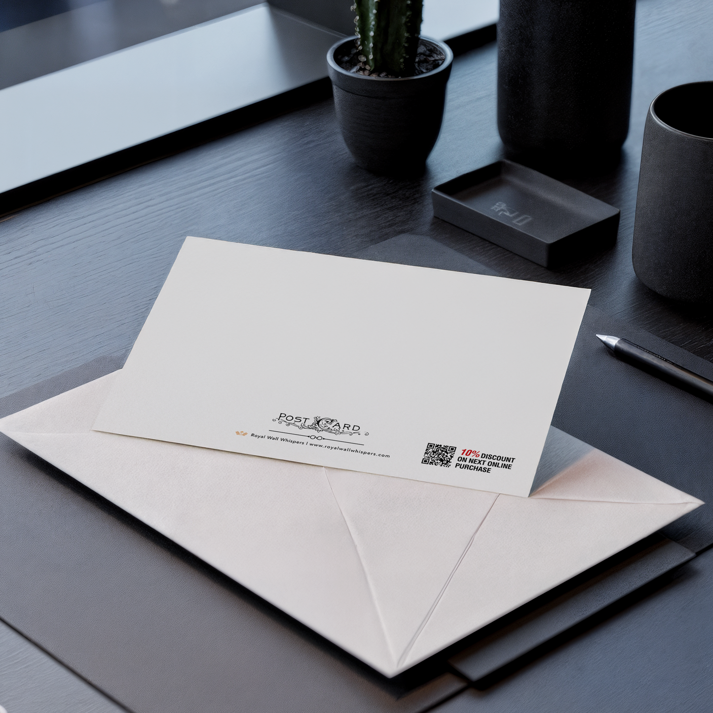 Envelopes with a postcard on a dark surface with a plant and other items.