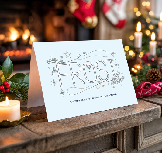 Christmas card with the word "Frost" on a festive background with candles and stockings.