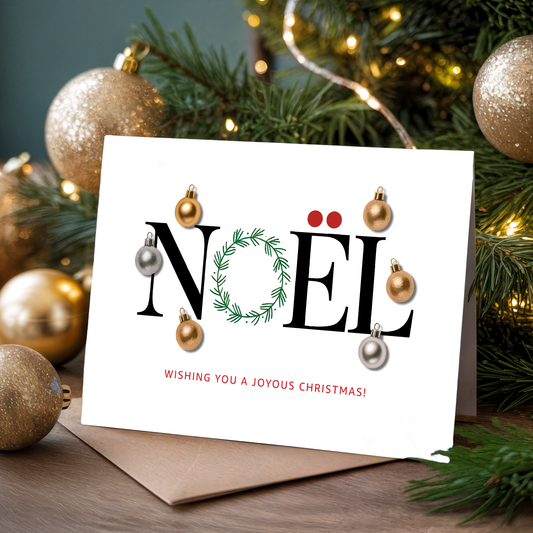 Christmas card with "Noël" and ornaments in front of a decorated tree.