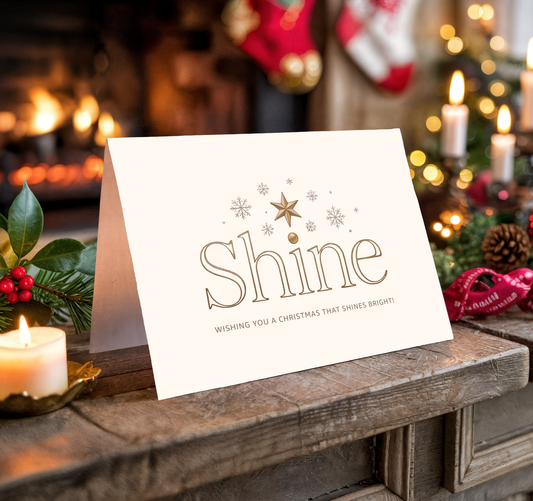 Christmas card with "Shine" text on a festive background with candles and decorations.
