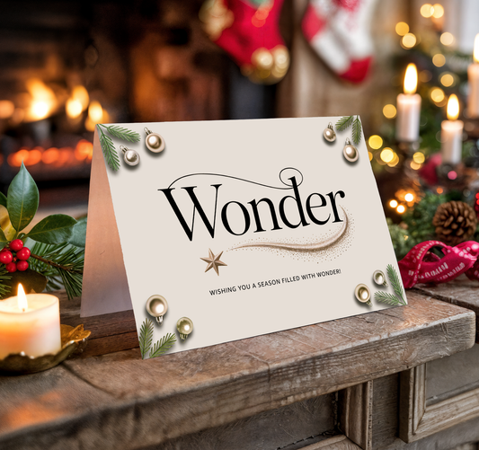 Christmas card with "Wonder" text on a festive background with candles and decorations.