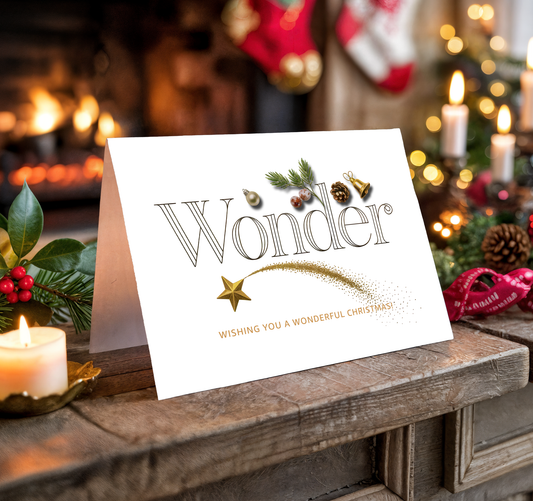 Christmas card with "Wonder" and festive decorations on a wooden surface with candles and stockings.