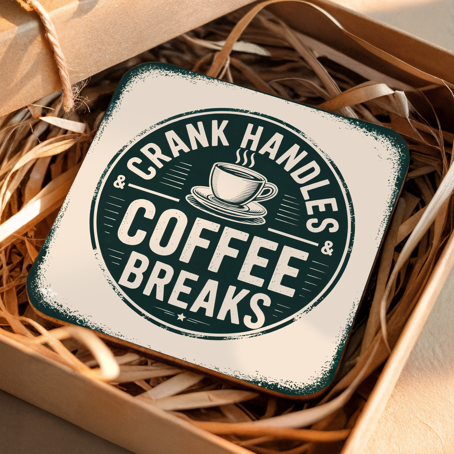 Coaster with "Crank Handles & Coffee Breaks" text on a woven background