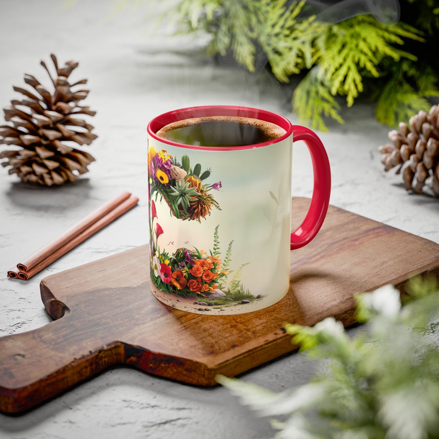 Mug with floral design on a wooden board with pine cones and cinnamon sticks.
