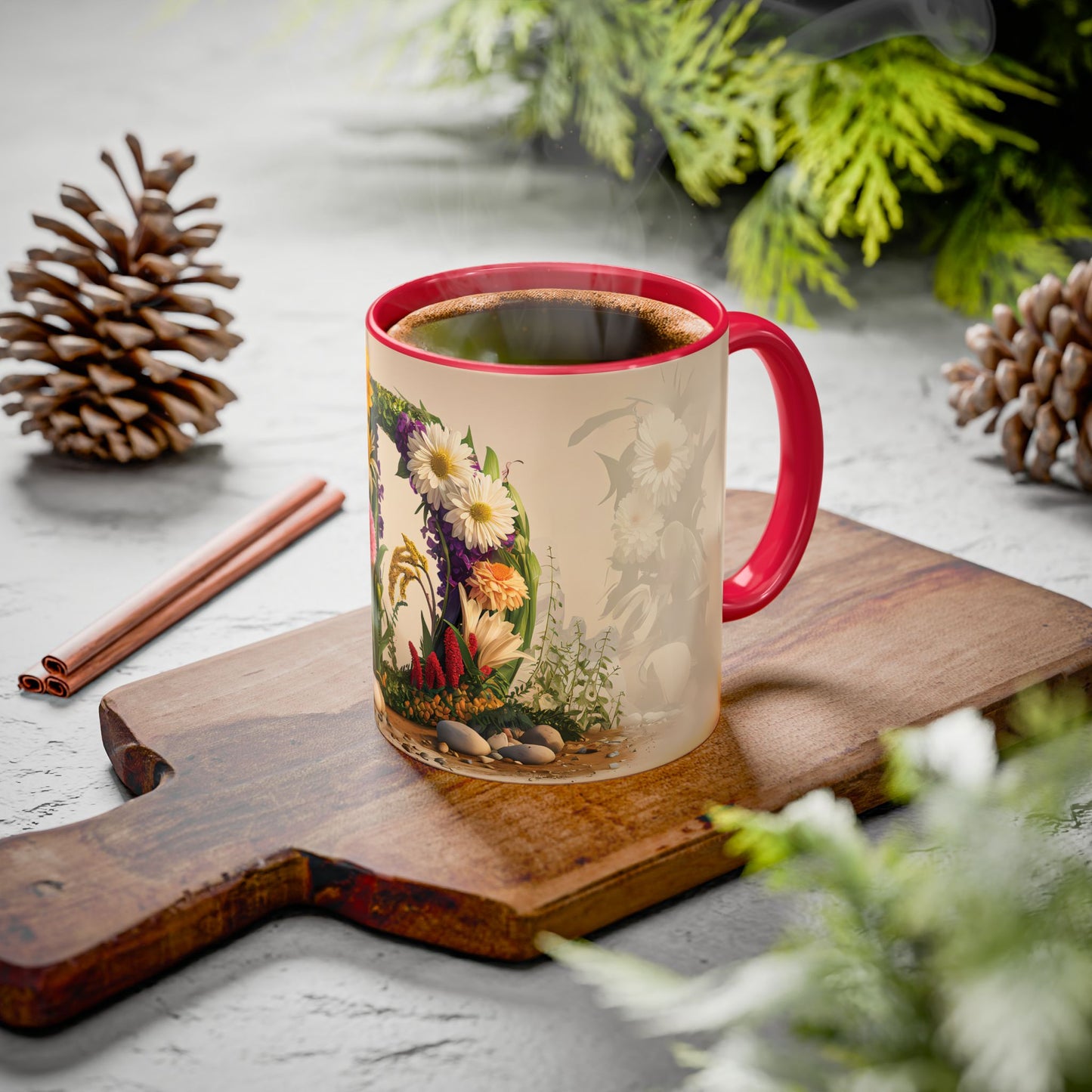 Mug with floral design on a wooden board with cinnamon sticks and pine cones.