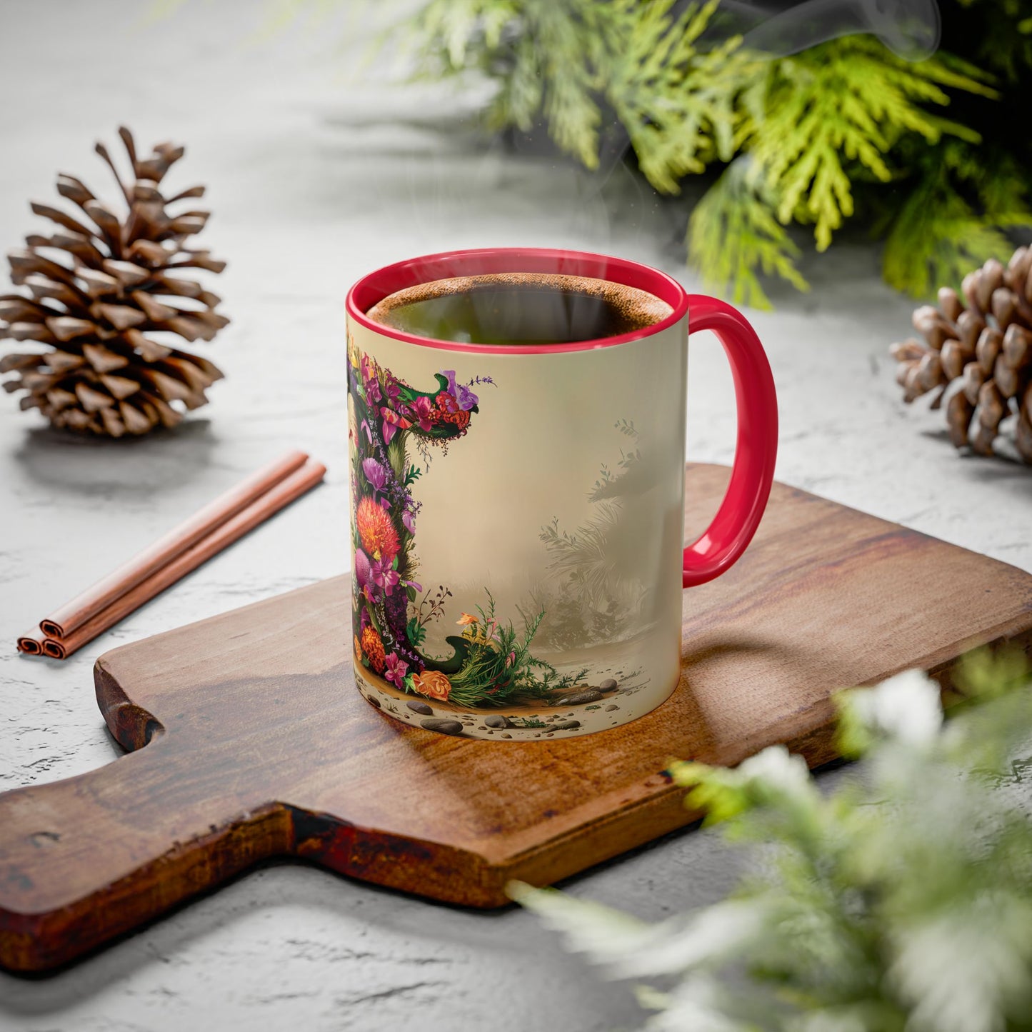 Mug with floral design on a wooden board with pine cones and cinnamon sticks