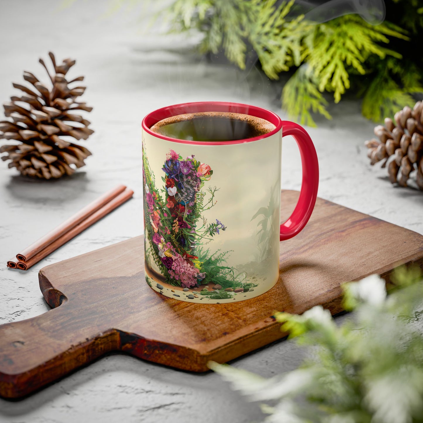 Mug with floral design on a wooden board with pine cones and cinnamon sticks.