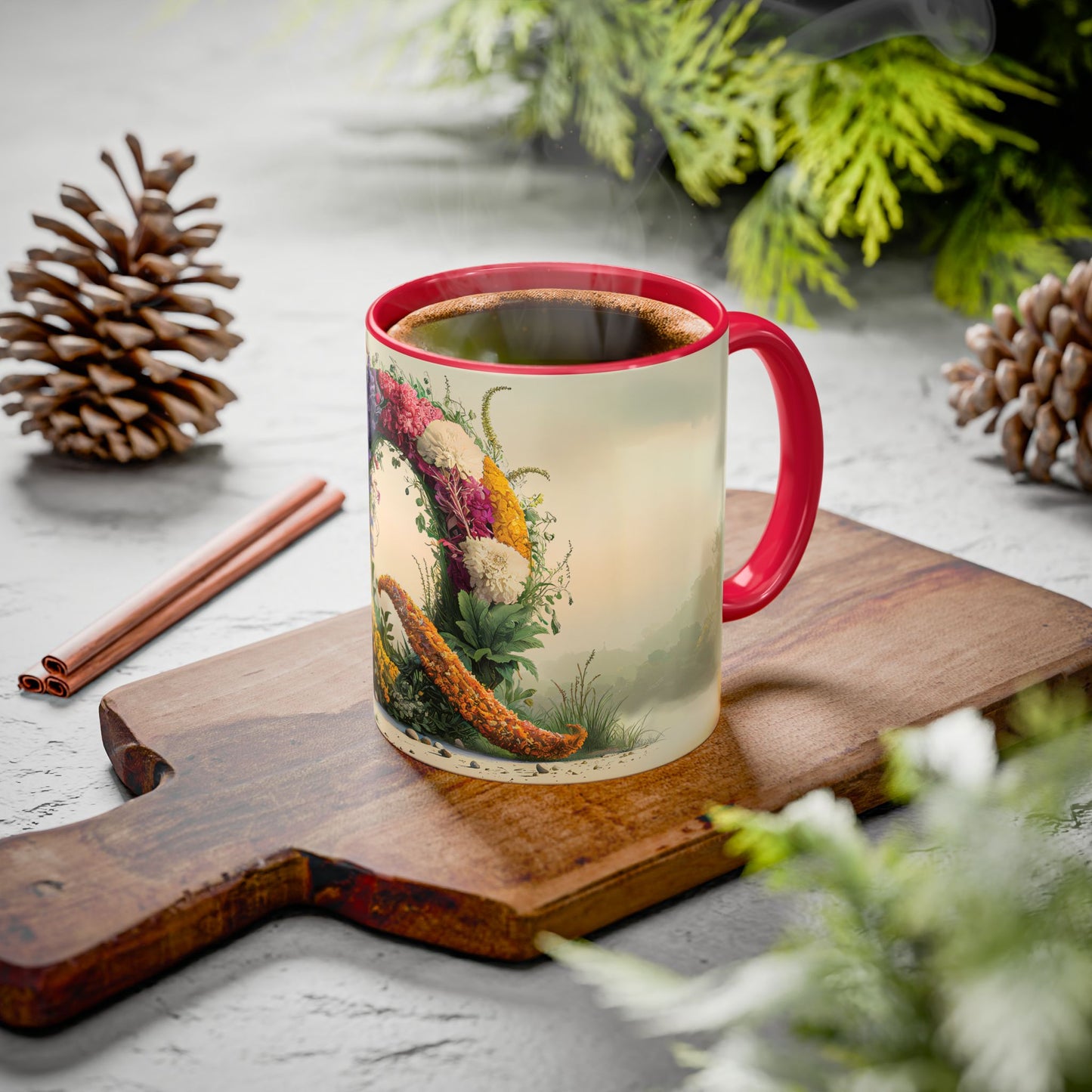 Mug with a floral design on a wooden board with pine cones and cinnamon sticks.