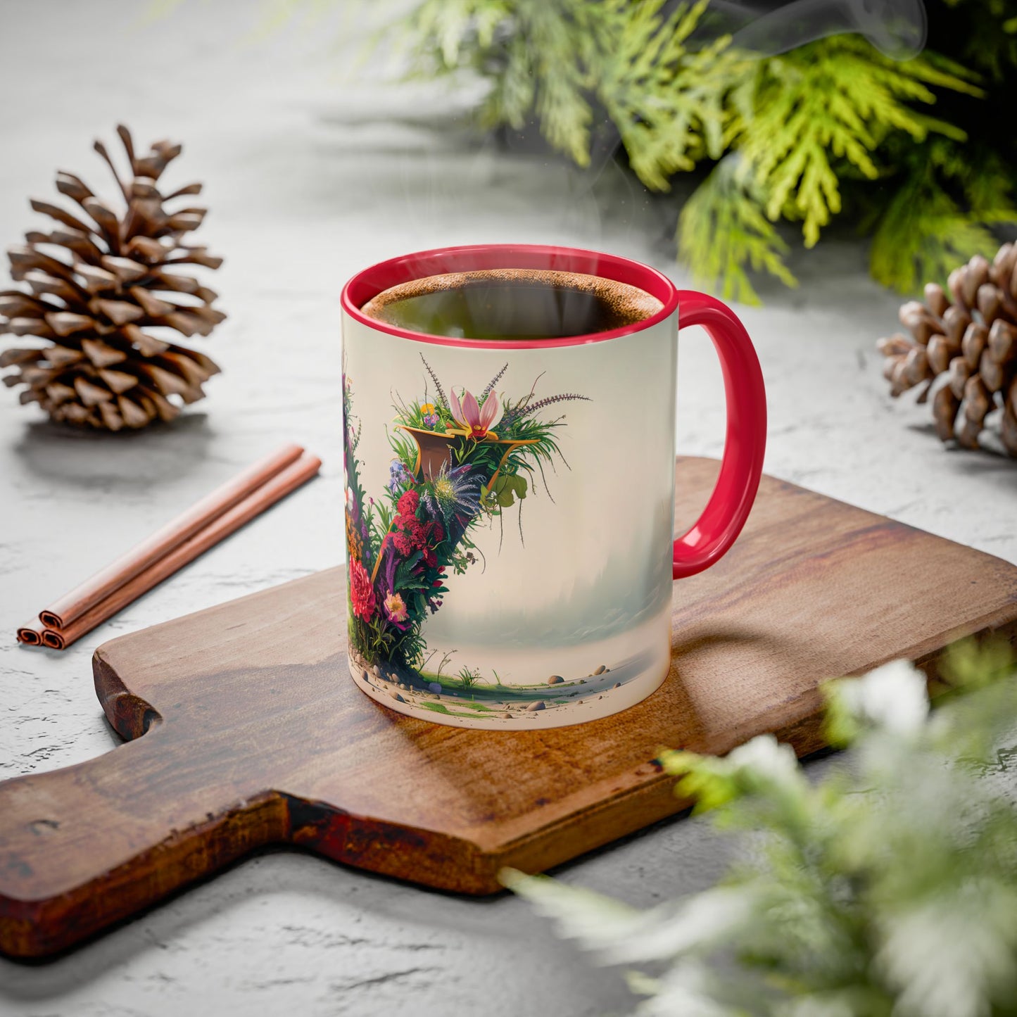 Mug with floral design on a wooden board with cinnamon sticks and pine cones.