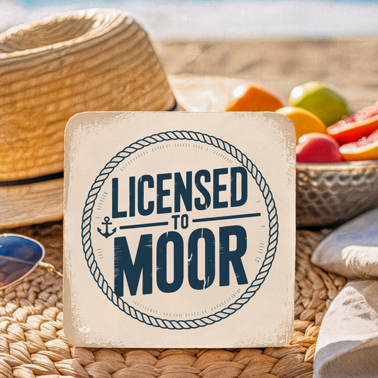 Coaster with "Licensed to Moor" text on a woven surface with fruit and sunglasses.