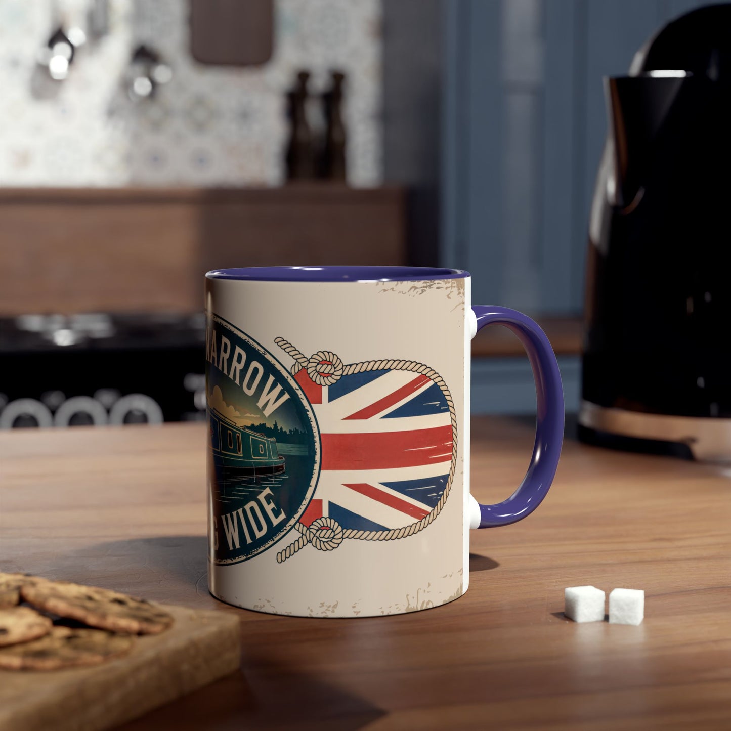 Mug with British flag design on a wooden table with cookies and sugar cubes.