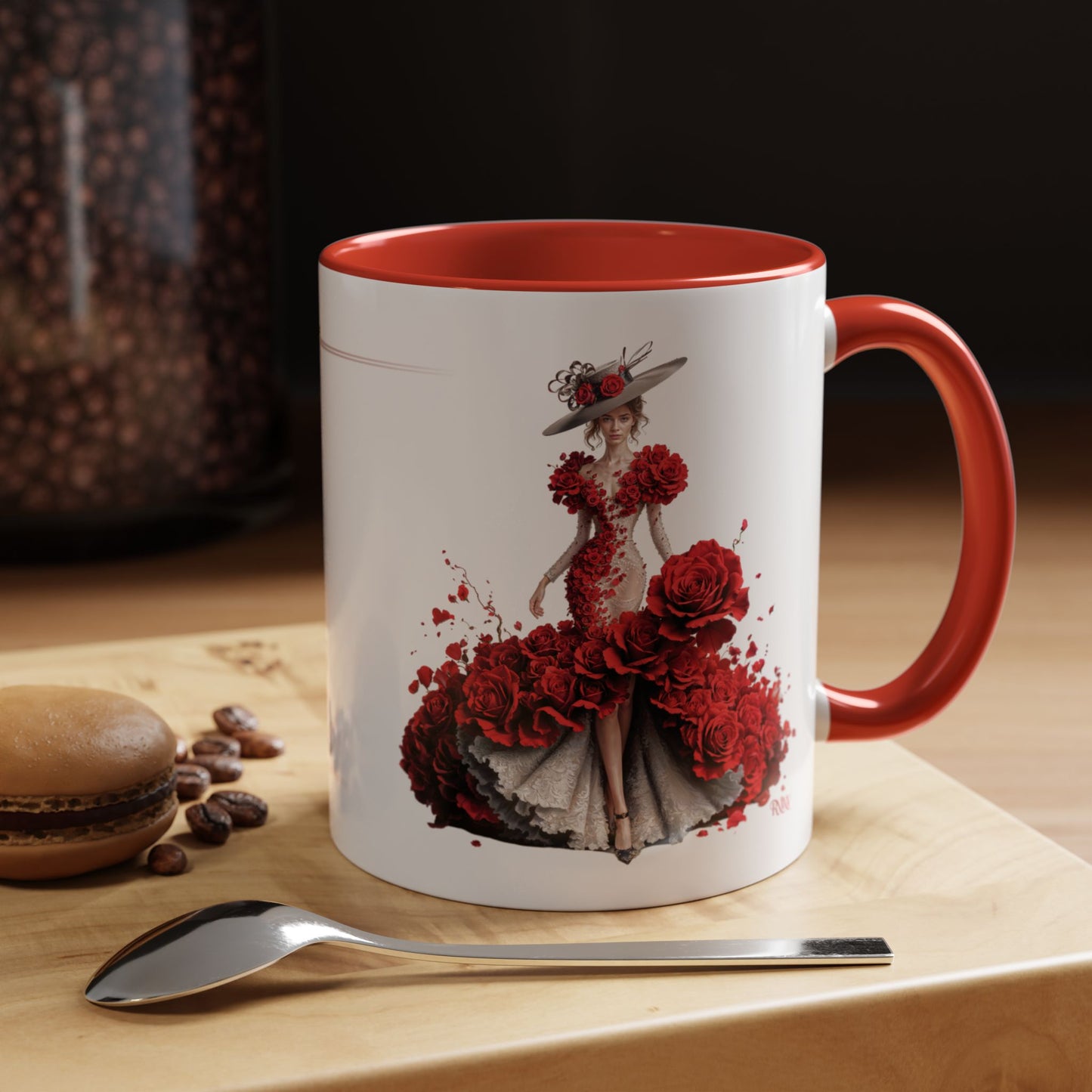 Mug with a floral design on a wooden surface with coffee beans and a spoon.