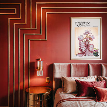 Decorative bedroom with red walls, a bed with pillows, and a framed poster on the wall.