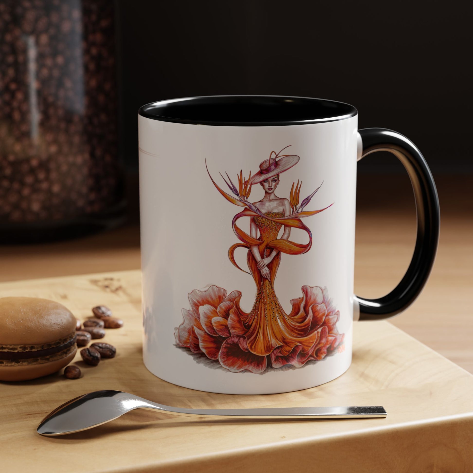Mug with artistic design on a wooden surface with coffee beans and a spoon.