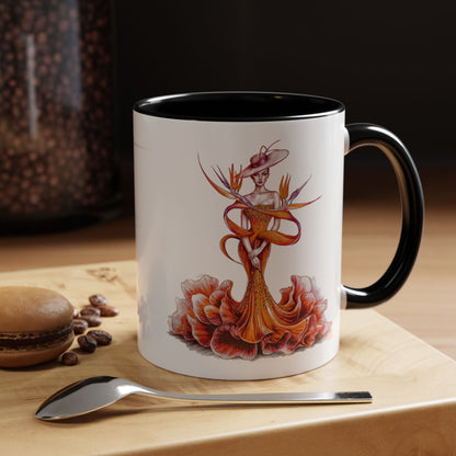 Mug with artistic design on a wooden surface with coffee beans and a spoon.