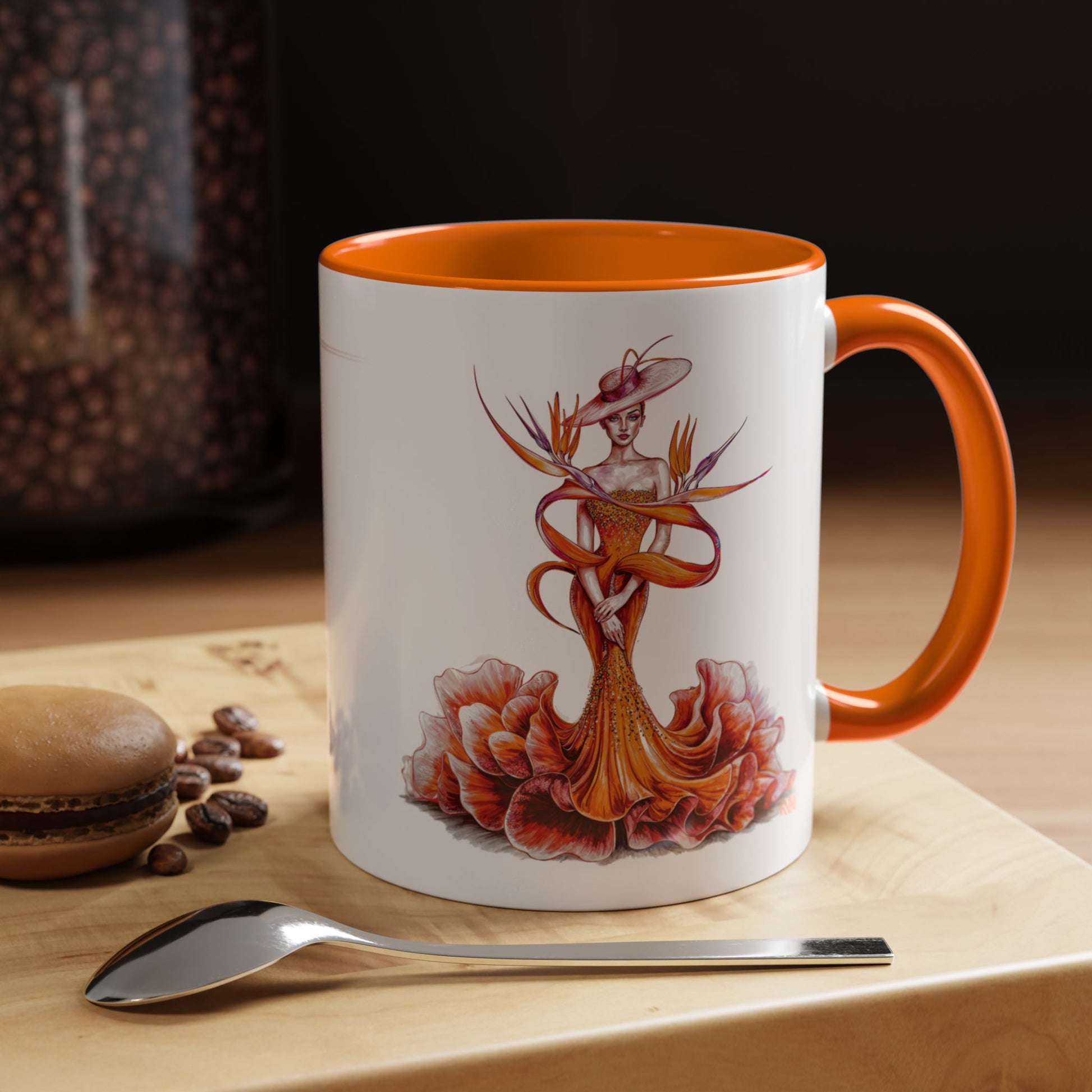 Mug with artistic design on a wooden surface with coffee beans and a spoon.