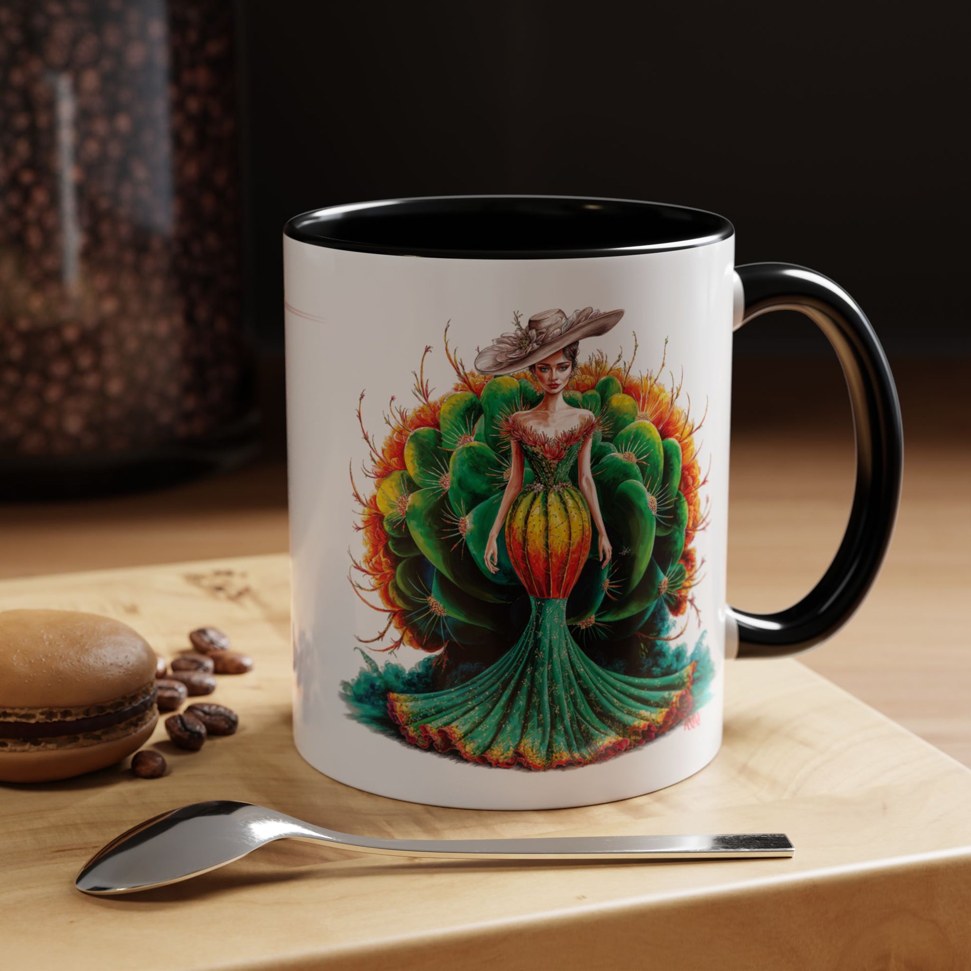 Mug with a colorful design of a woman in a dress on a wooden surface with coffee beans and a spoon.
