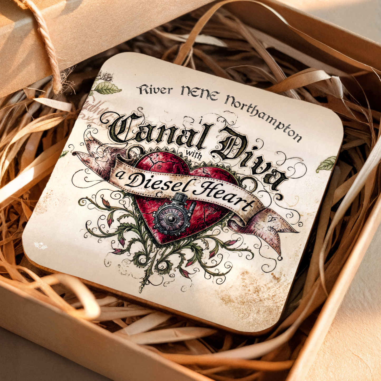 Coaster with decorative text and heart design on a bed of straw