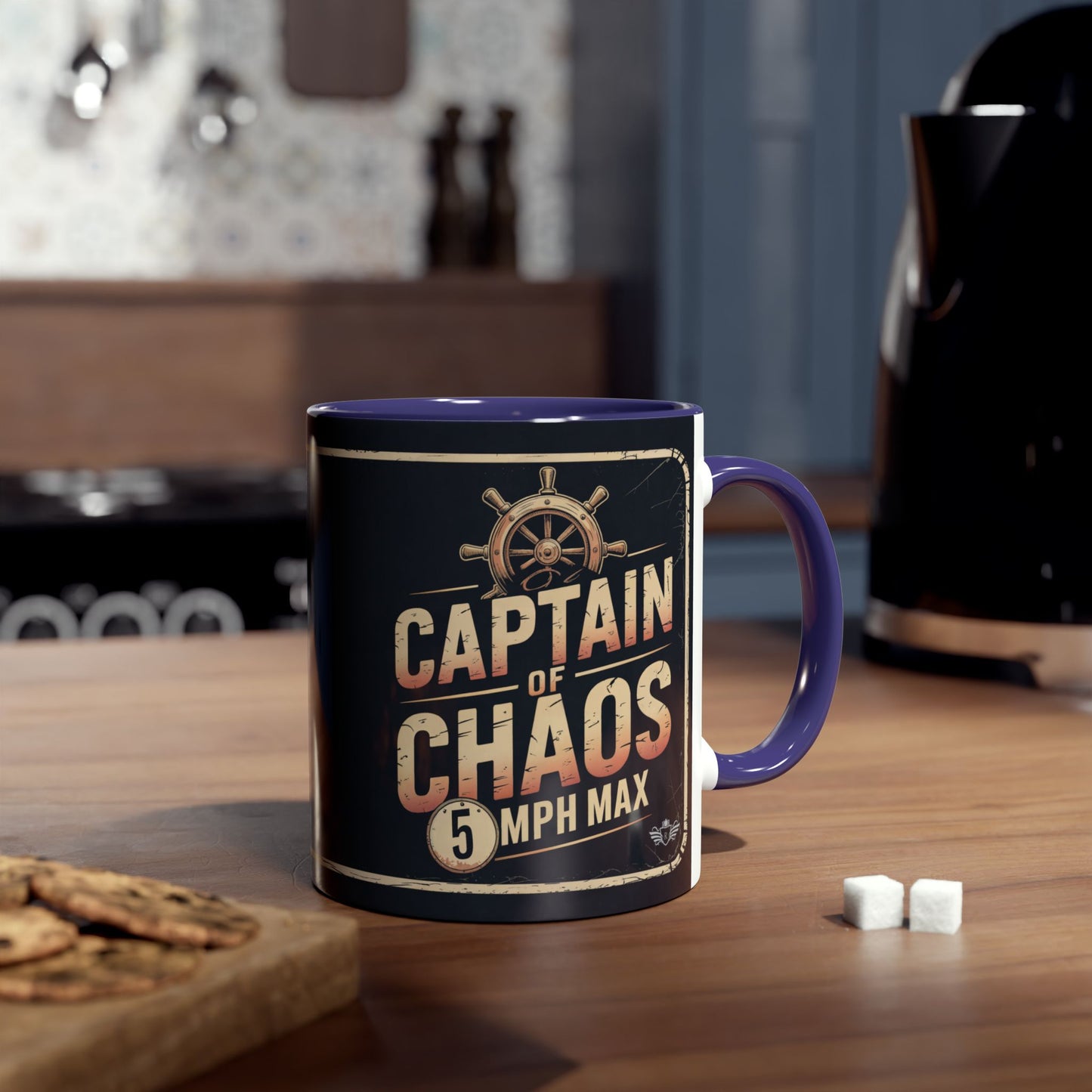 Mug with "Captain of Chaos 5 MPH Max" design on a wooden table.
