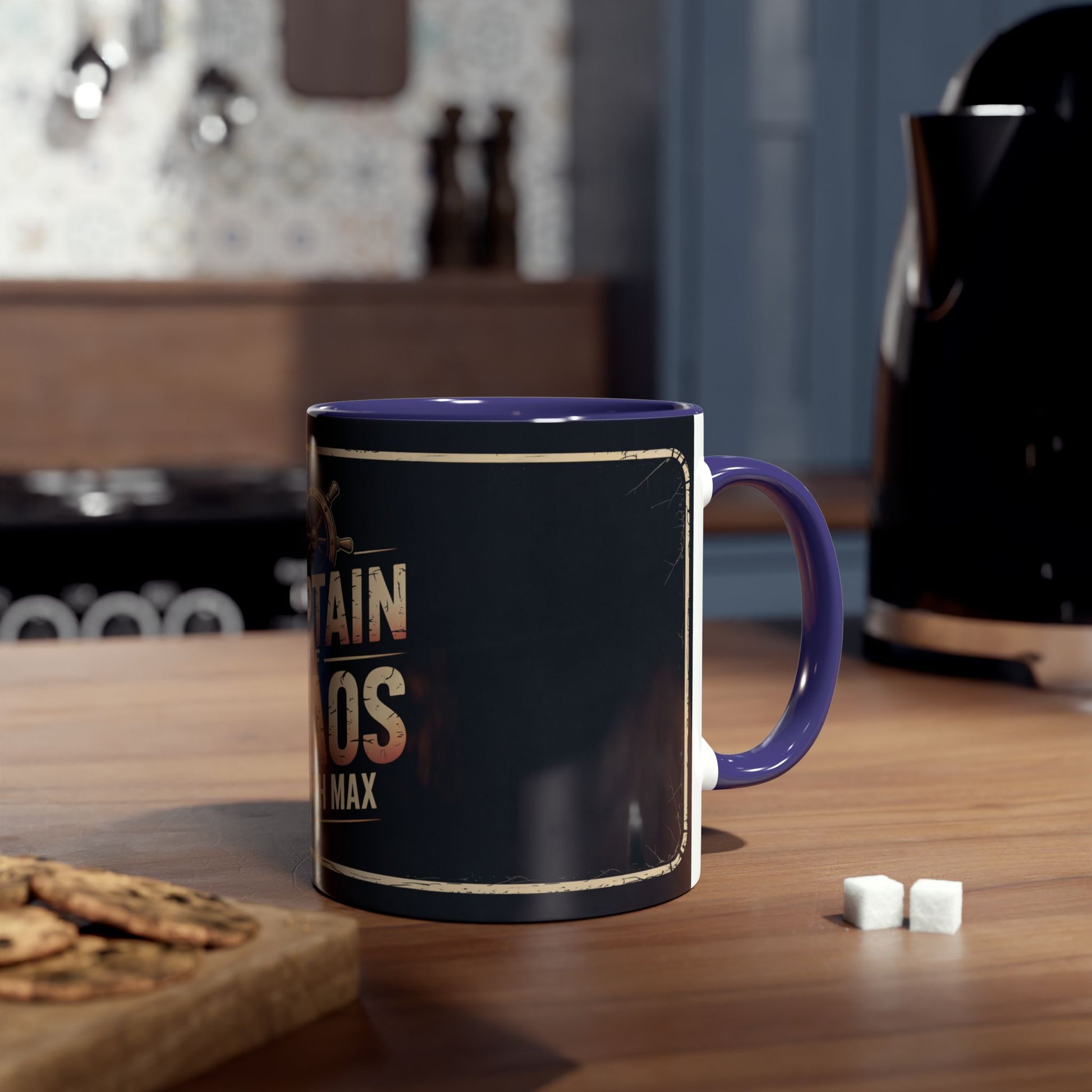 Black mug with blue handle on a wooden table with cookies and sugar cubes.