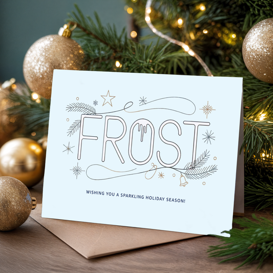 Christmas card with "Frost" design in front of a decorated tree