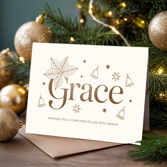 Christmas card with "Grace" design in front of festive decorations