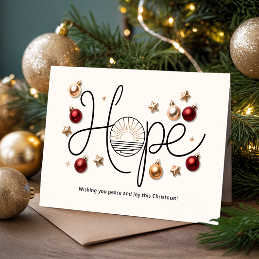 Christmas card with "Hope" and festive decorations in front of a decorated tree.