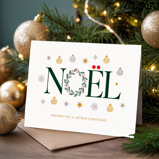 Christmas card with "Noël" and festive decorations in front of a Christmas tree.