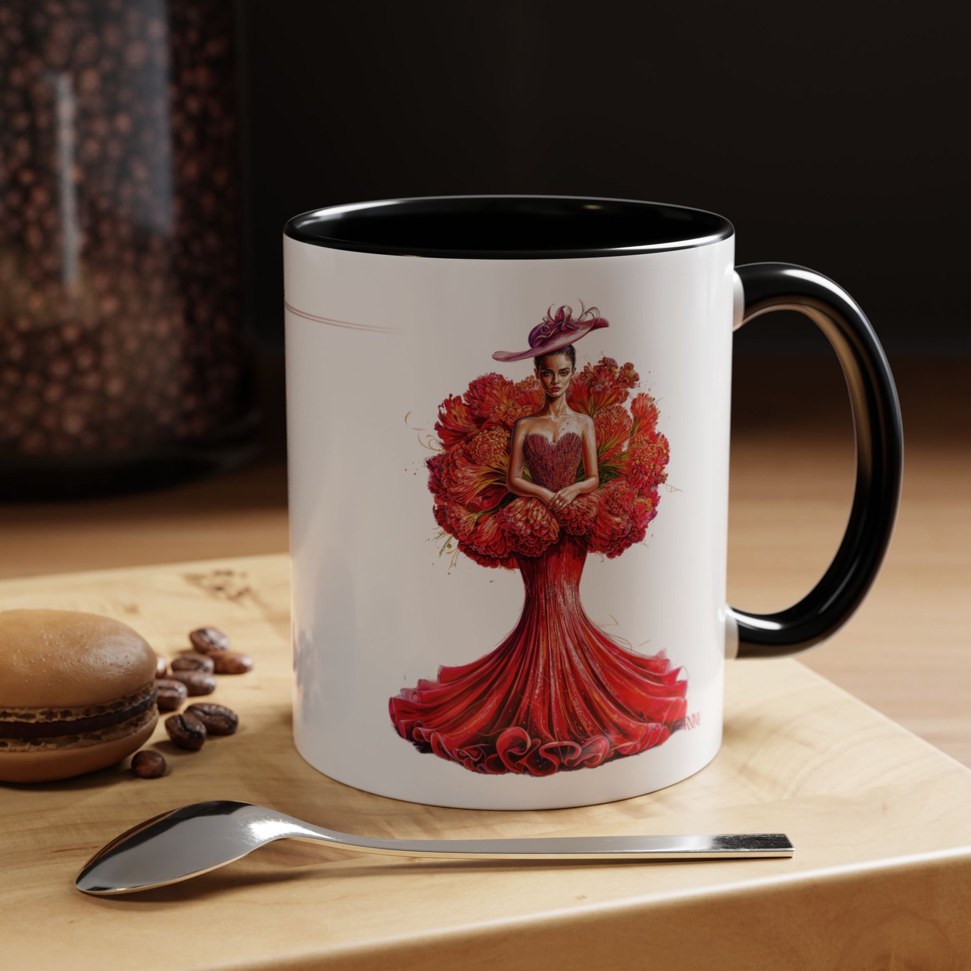 Mug with artistic design of a woman in a red dress on a wooden surface with coffee beans and a spoon.