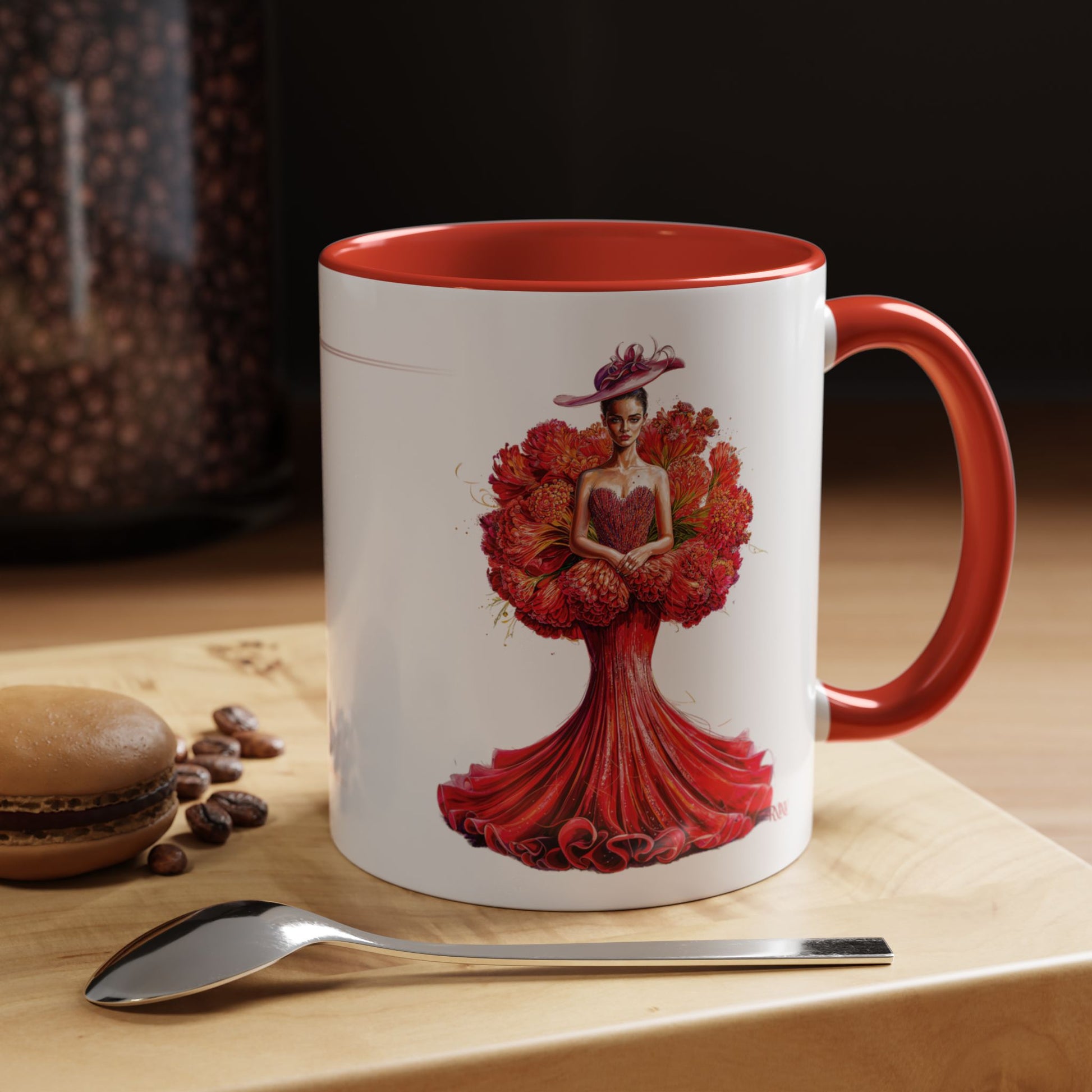 Mug with a floral design on a wooden surface with coffee beans and a spoon.