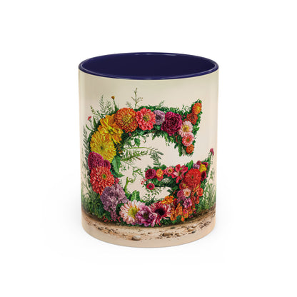 Mug with floral design and letter 'G' on a white background