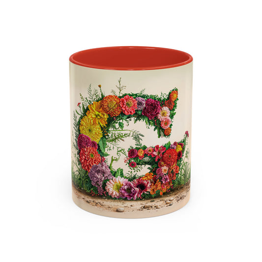 Mug with floral design and red interior on a white background