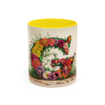 Mug with floral design and yellow interior on a white background