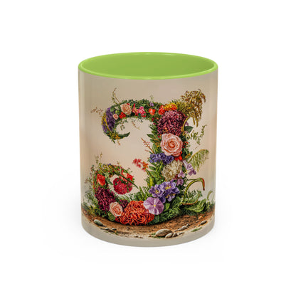 Mug with floral design and green interior on a white background