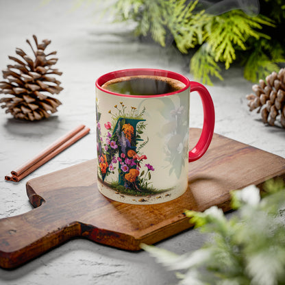 Mug with floral design on a wooden board with pine cones and cinnamon sticks.