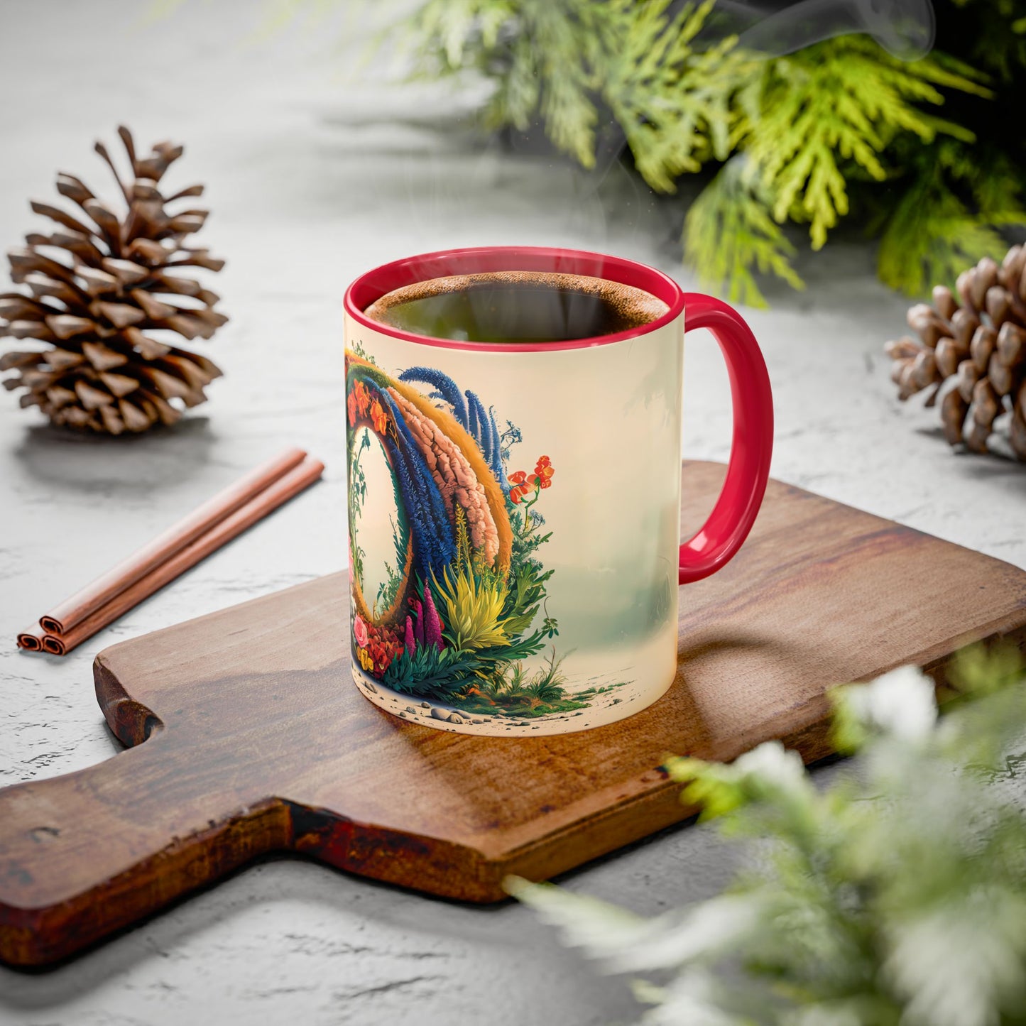 Mug with colorful design on a wooden board with pine cones and cinnamon sticks.