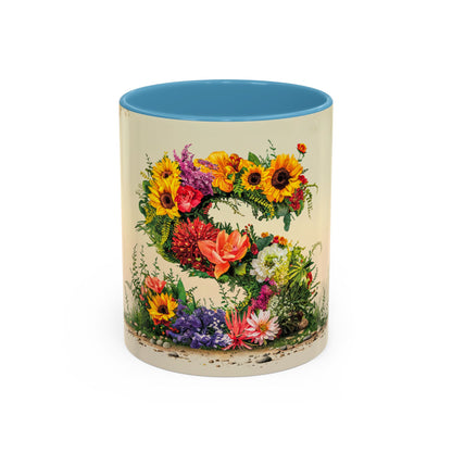 Mug with floral design and blue interior on a white background