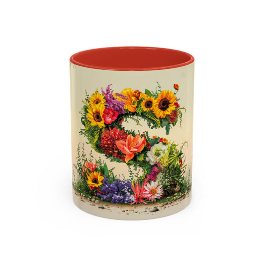 Mug with floral design and red interior on a white background