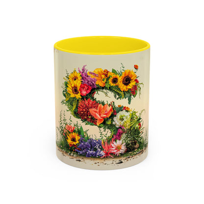 Mug with floral design and yellow interior on a white background
