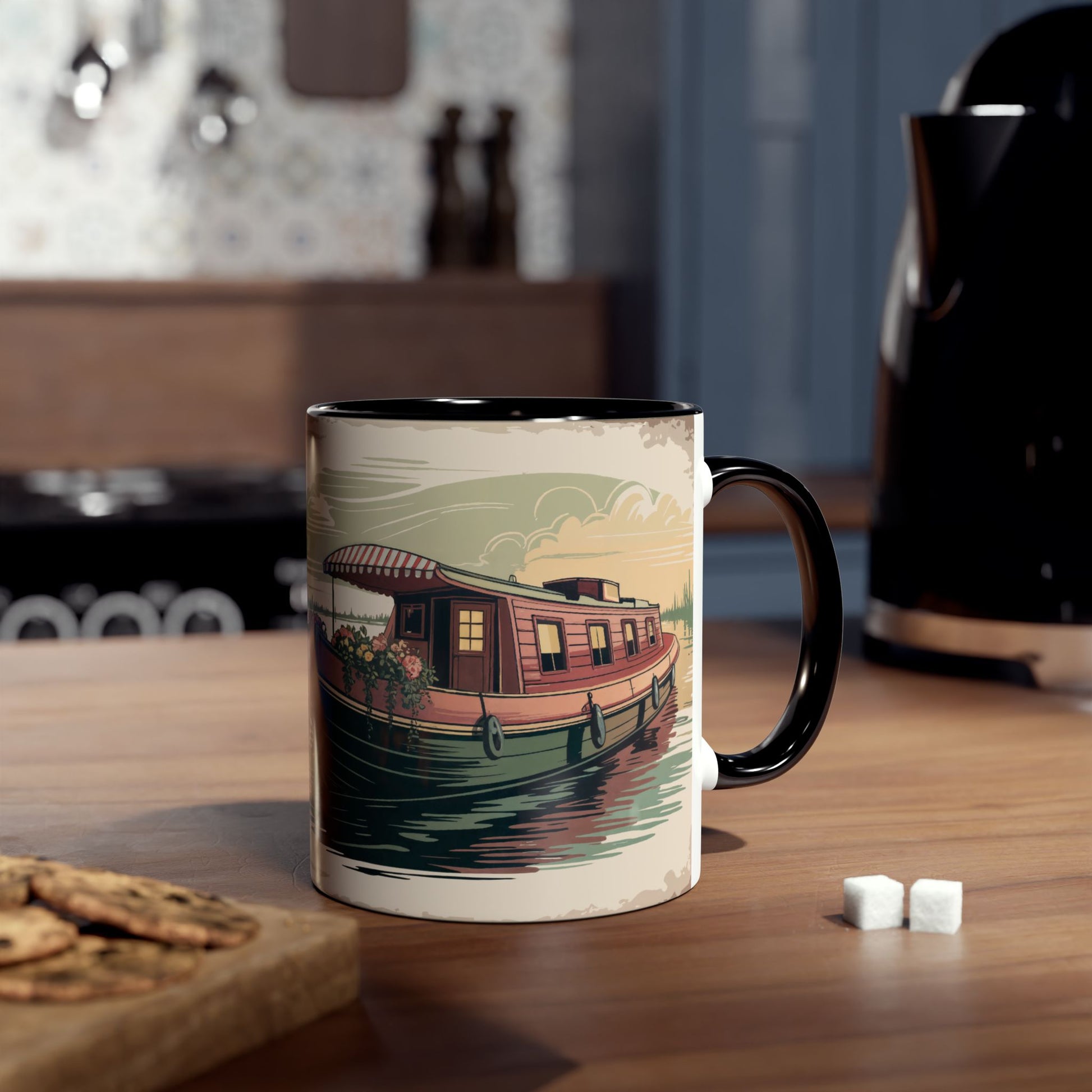 Mug with a boat illustration on a kitchen counter with cookies and sugar cubes.