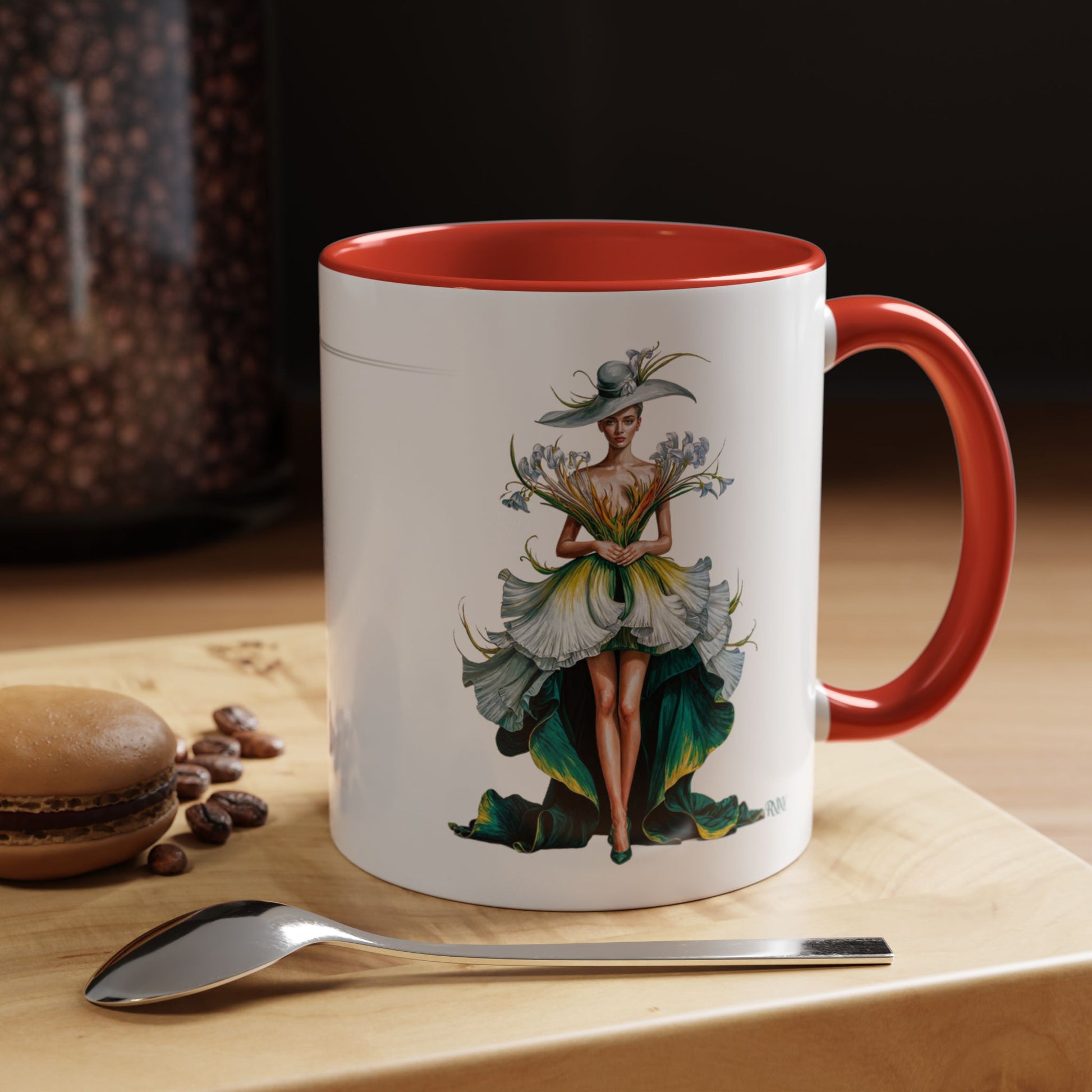 Mug with a colorful design of a woman on a wooden surface with coffee beans and a spoon.