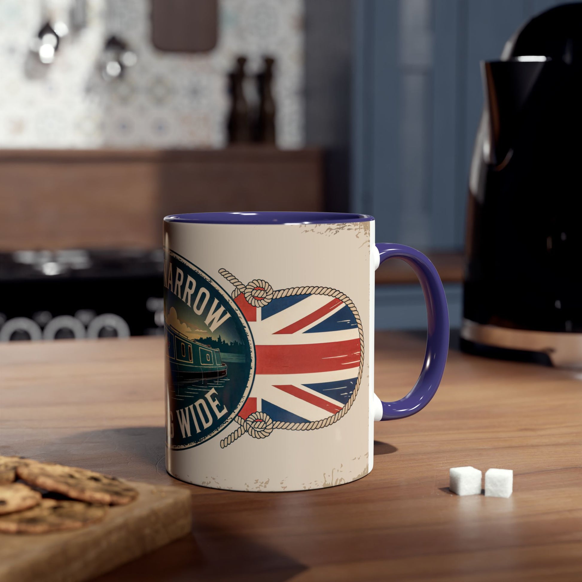 Mug with British flag design on a wooden table with cookies and sugar cubes.