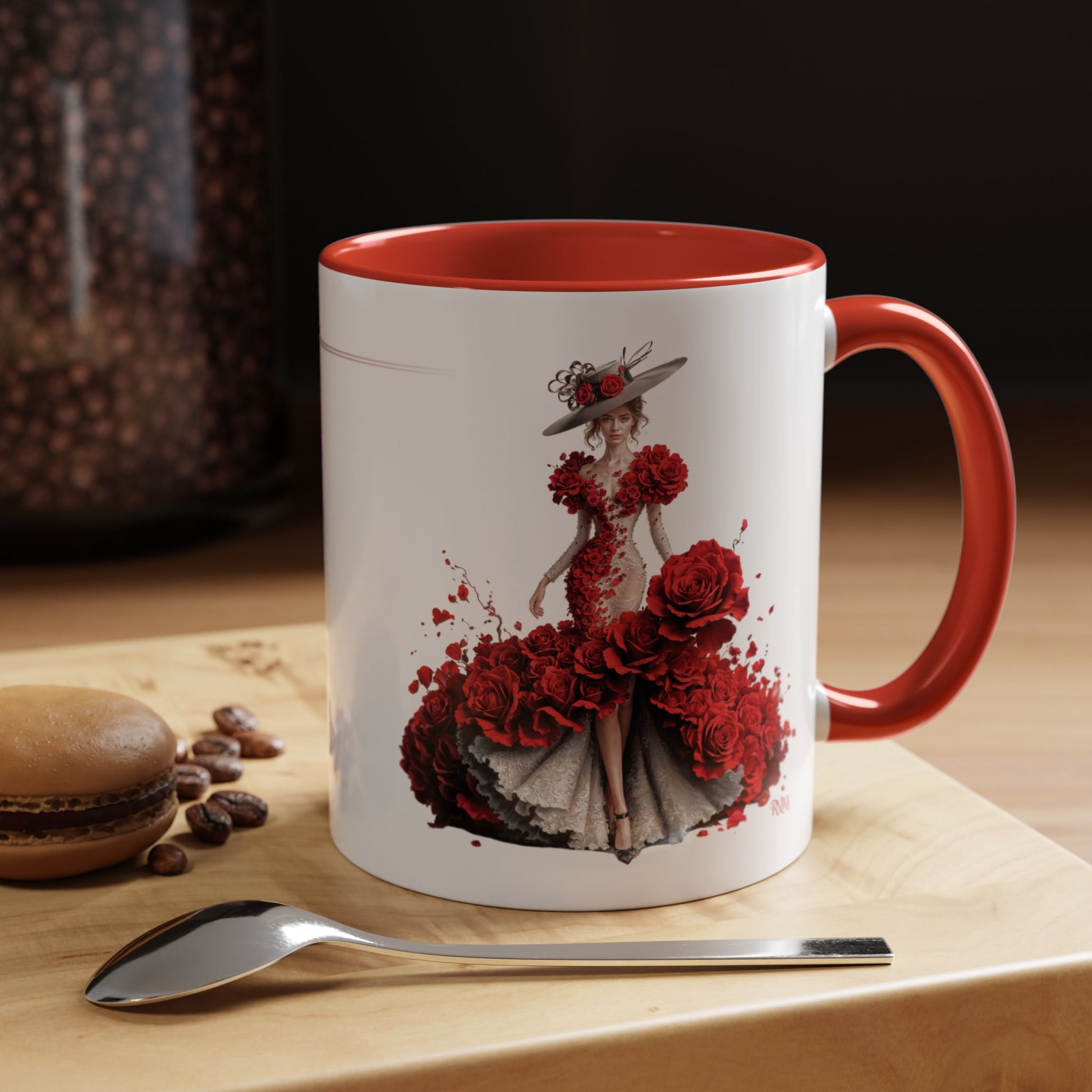 Mug with a floral design on a wooden surface with coffee beans and a spoon.